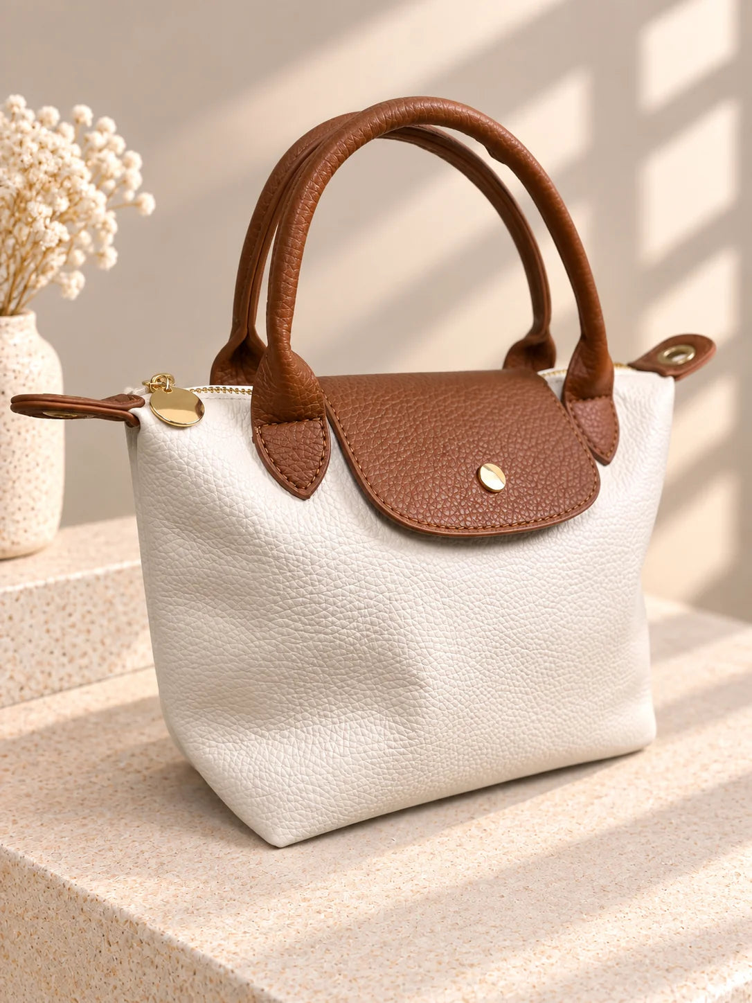 Bolsa Lia branca com aba castanha, vista de três quartos